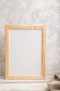 White wooden frame mockup with linen textile on gray concrete background. Blank, vertical