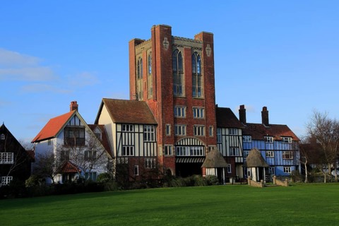 Eccentric mock Tudor architecture of water tower and houses, Thorpeness, Suffolk, England, United