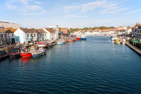 Colourful fishing boats in the harbour at Weymouth, Dorset, England, UK