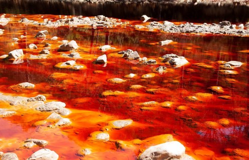 Blood red mineral laden water Rio Tinto river Minas de Riotinto mining area, Huelva province,