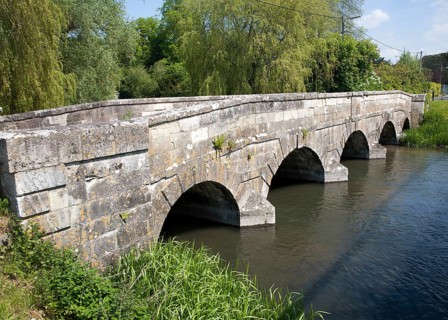 Stone bridge crossing River Avon chalk river at Amesbury, Wiltshire, England, United Kingdom,