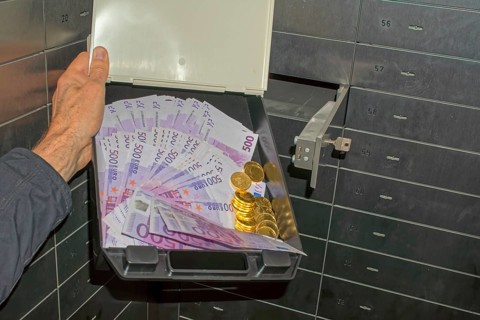 Money and gold in a bank safe deposit box