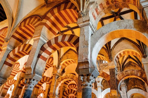 Moorish arches in columned hall, incidence of light in Mezquita, former mosque, interior view,