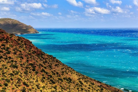 Mirador de La Amatista with view of rocky coast and turquoise sea, coastline at La Isleta, sunny