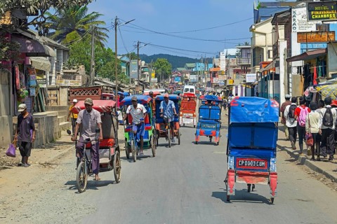 Cycle rickshaws, cyclo-pousses, velotaxis in bust street in the city Moramanga, Alaotra-Mangoro