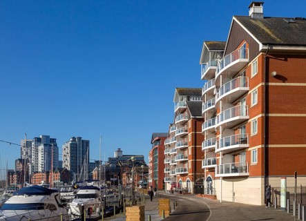 Apartments and high rise flats with boats in marine on the waterfront, Wet Dock, Ipswich, Suffolk,