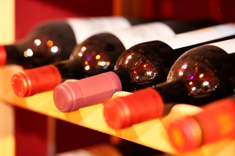 Wine cellar with red wine bottles