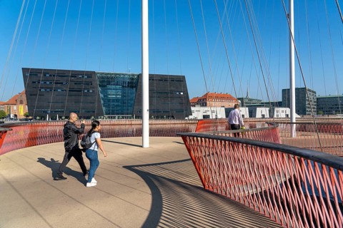 Cyclists on the Cirkelbroen cycle and footpath bridge, over the harbour, in the Christianshavens