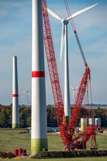 Assembly of a wind turbine, the last rotor blade is being mounted, mobile crane, wind turbine from