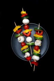 Colourful vegetable skewers on a plate, barbecue skewers
