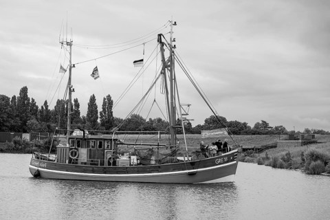 Fishing boat entering the harbour, Greetsiel, East Frisia, Lower Saxony, Germany, Europe