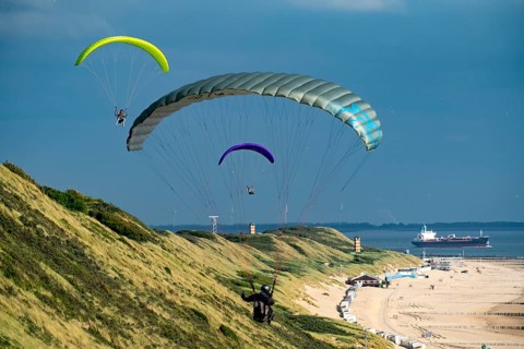 Paragliders along the dunes of Zoutelande, in Zeeland, South Holland, Netherlands