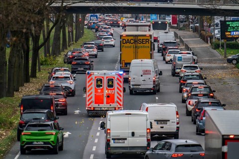 Rescue lane, ambulance making its way through city centre traffic with blue lights and siren,