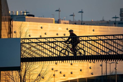 Cyclist on a bridge over Segerothstraße, in Essen, behind Limbecker Platz shopping centre