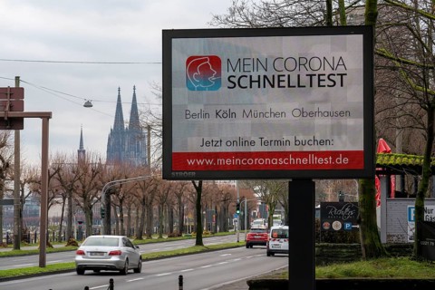LED billboard, with digital advertising for Corona rapid tests, in the test centre in Cologne, on