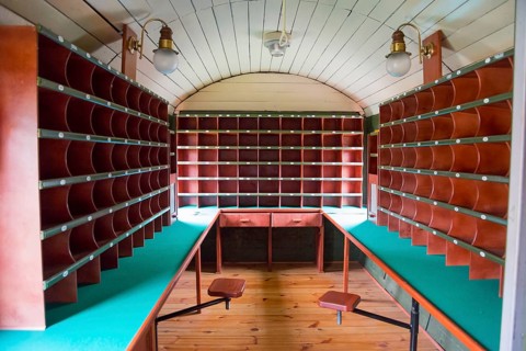 Interior view of a mail coach with wooden shelves and desks, mail coach, railway museum, Elk, Elk,