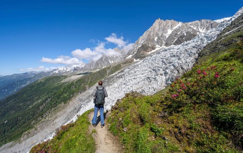 Mountaineer on the hiking trail La Jonction, mountain landscape with glacier Glacier des Bossons