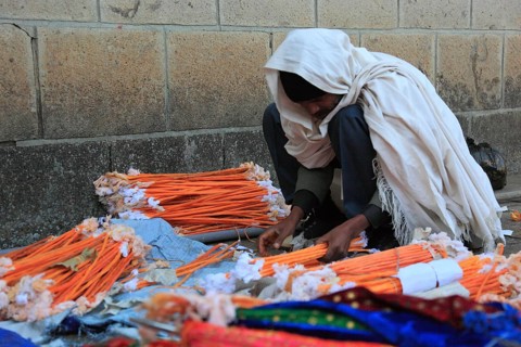 Europia district, Debre Lebanon, Lipanus monastery, man sorting wax torches for the pilgrims at the