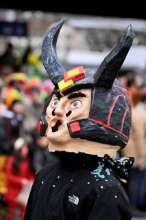 Person masked as a devil at the carnival parade of the Wey guild on Rose Monday, Güdismäntig,