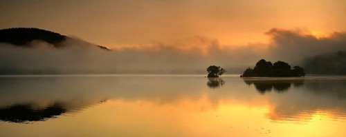 Sunrise at the Edersee with morning mist on the water, small islands in the Edertalsperre,