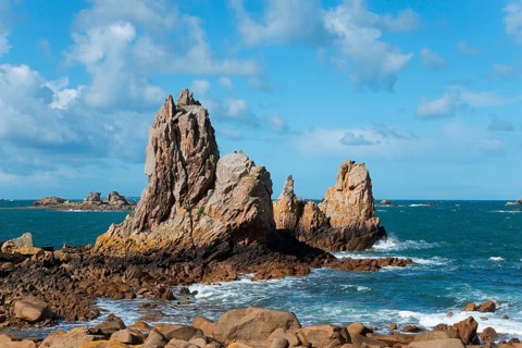 Rough sea on a rocky coast under a cloudy sky, Plage de Pors Scaff, Plougrescant, Côtes-d'Armor,