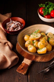 Fresh Cooked, new potatoes, with dill, on a wooden table, selective focus. close-up, toning, no