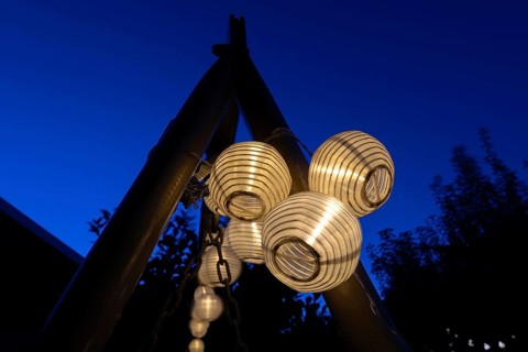 Lanterns, paper lanterns, fairy lights in a garden, blue hour, Germany, Europe