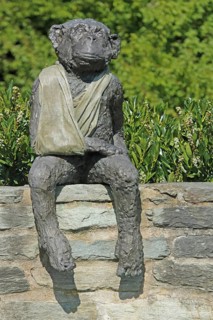 Sculpture A & E Monkey by Laura Ford, monkey figure, sitting, injury, cloth, arm bandage, bandage,