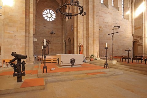 Interior view with chancel of the Romanesque abbey church, altar, candlestick, book stand,