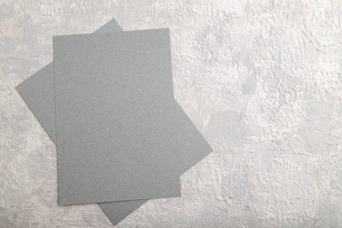 Gray paper business card, mockup on gray concrete background. Blank, flat lay, top view, still