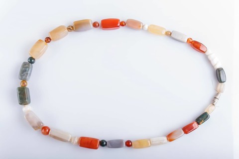 Colored onyx beads isolated on white background. top view, close up