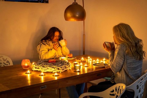 Symbolic image energy saving, cold winter, energy crisis, cold flat, mother and daughter dressed