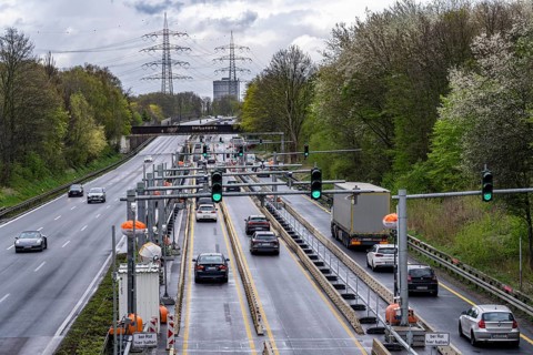 Weighing and barrier system on the A42 motorway, in front of the dilapidated motorway bridge over