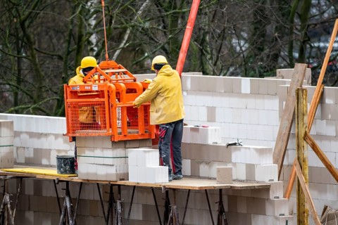 Building site, house being built, bricklayers at work, building a wall, on scaffolding, high