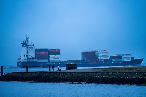 Thick fog in winter, hangs over the mouth of the Elbe into the North Sea, container ship enters the