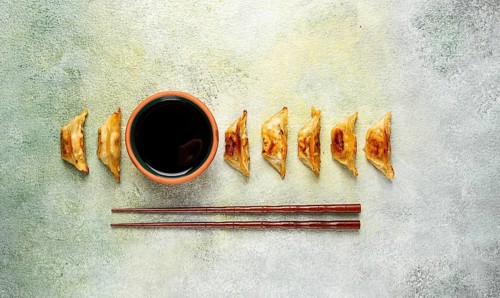 Japanese fried dumplings, gyoza, sesame seeds, top view, no people