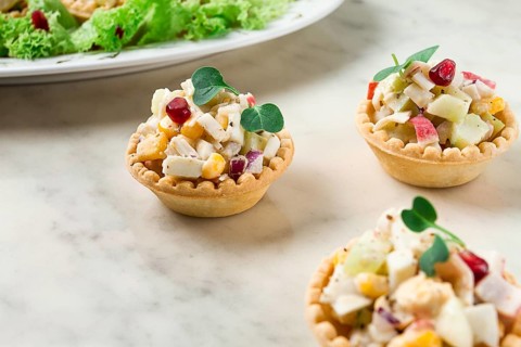 Canapes with salad, corn with crab sticks, appetizer, portioned, close-up, no people