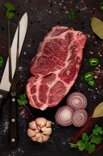 Pork neck, raw tenderloin, with spices, on the table, top view, no people, black background