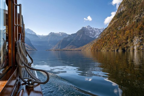 Tourist boat on the Königssee, Watzmann massif, autumnal mountain landscape reflected in the lake,