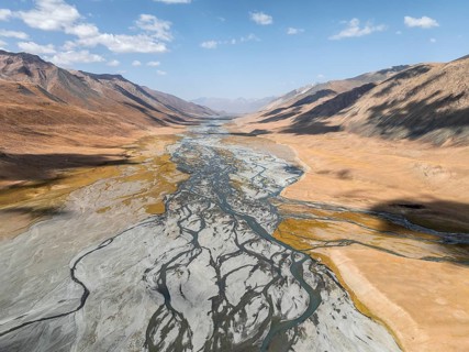 Aerial view, Burkhan mountain valley with meandering river, barren dramatic mountain landscape,