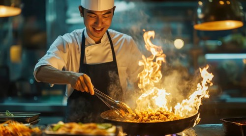 Thai asian cuisine. Chef in apron preparing delicious thai deep fried food over the fire., AI
