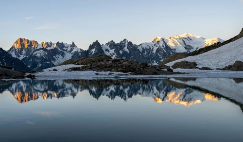 Morning atmosphere, mountain landscape at sunrise, water reflection in Lac Blanc, mountain peak,