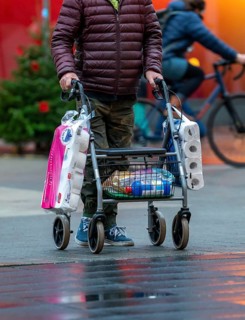 Man with rollator buys 2 large packs of toilet paper, The city centre of Bochum, on the day of the