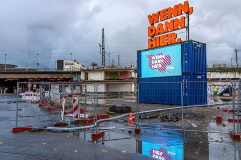 Central station, construction site for a new building, illuminated advertising, neon sign, digital