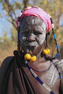 South Ethiopia, in Maco National Park, Mursi tribe, Mursi woman with painted skin and earrings,