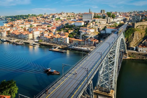 View of Porto city and Douro river and Dom Luis bridge I with metro tram from famous tourist