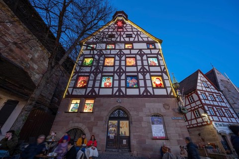 Main façade of the historic Pilatushaus with an Advent calendar designed by the Altstadtfreuden
