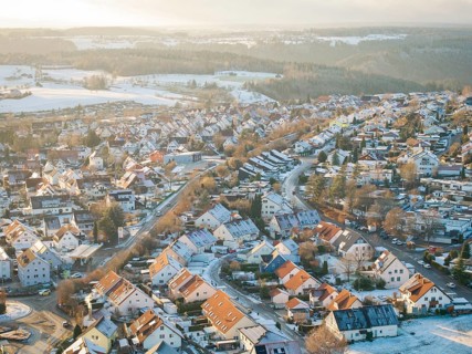 Snow-covered town roofs and winding streets in a wintry landscape, Calw- Stammheim, Black Forest,