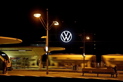 Wolfsburg main station at night with illuminated VW logo at the Volkswagen AG main plant, Lower