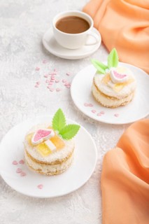 Decorated cake with milk and coconut cream with cup of coffee on a gray concrete background and